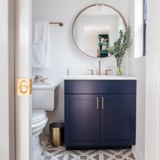 Modern Guest Bathroom with Gold Accents and Geometric Tiles