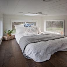 White Tiny House Loft Bedroom With Stained Wood Floor And Panoramic Windows