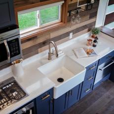 Tiny House Kitchen With White Countertops And Blue Cabinets
