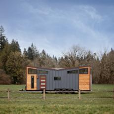Modern Tiny House Exterior With Blue Metal And Natural Wood Siding