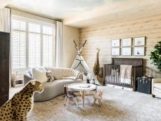 This safari-themed nursery, designed by Stephanie Avila, combines nursery and playroom all in one. Featuring baby animal artwork, a tepee, and stuffed animals, this nursery accomplishes its safari-chic theme.