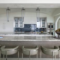Neutral Open Plan Kitchen With Rounded Barstools