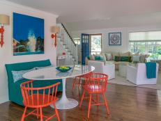 This coastal home, by Martha's Vineyard Interior Design, is the perfect summer getaway. Throughout the home there are pops of orange that give the space a fun and energetic vibe.