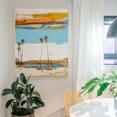 Neutral Tropical Dining Room with Multicolor Wall Art