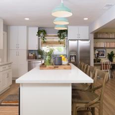 Contemporary White Open Plan Kitchen with Brown Hardwood Floors 