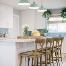 Contemporary White Kitchen with White Island and Brown Stools 
