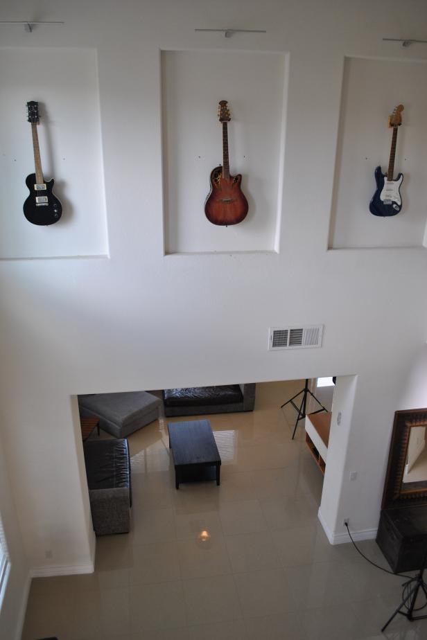 A unique guitar display on the wall above the living room at the winners new home, as seen on My Lottery Dream Home.
