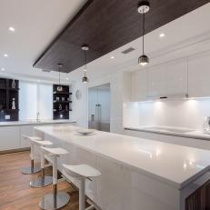 White Modern Galley Kitchen With White Barstools