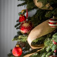 Red And Gold Ornaments And Trim Add Warmth To A Holiday Tree