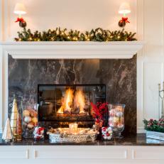 Traditionally Decorated Marble Fireplace With Red And Metallic Accents