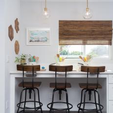 Contemporary White Kitchen with Brown Chairs 