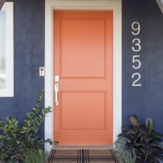 Eclectic Blue Home Exterior with Orange Front Door 