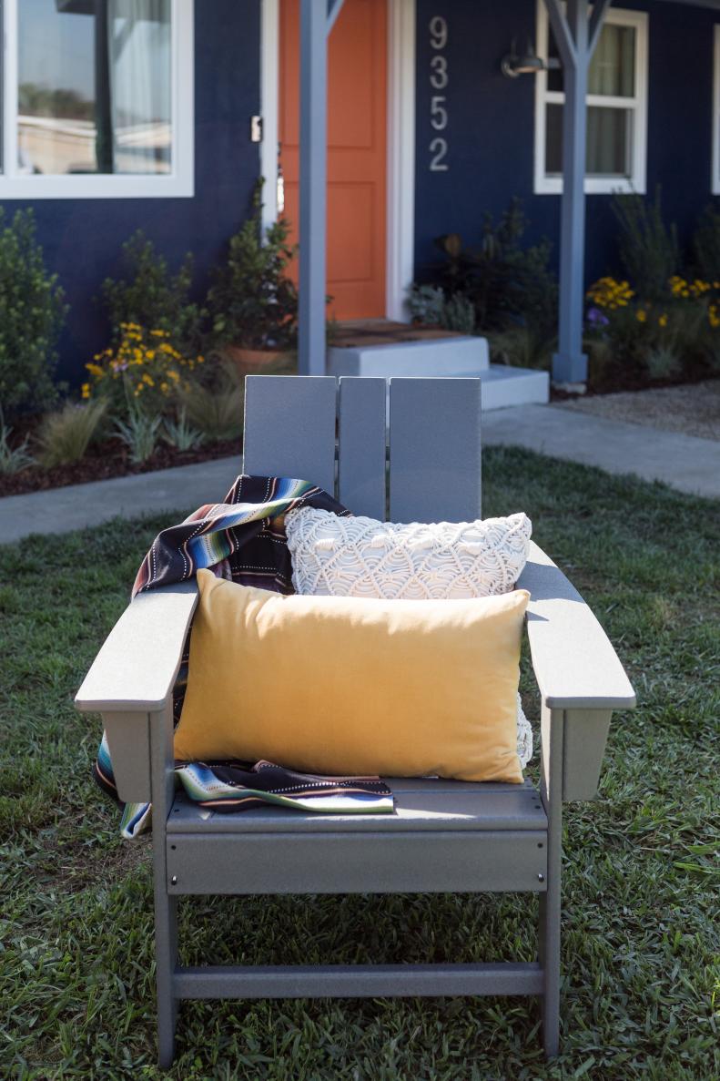 Gray Lawn Chair with Yellow Pillow, Blue, Green and White Blanket