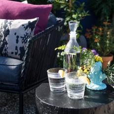 Eclectic Blue Outdoor Seating Area with Black Table 