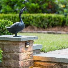 Cottage Garden Detail With Brick Path And Duck Sculpture Accent