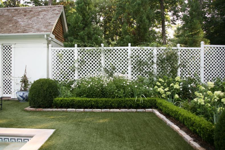 White lattice provides a crisp, clean border in this stunning Atlanta garden. Danielle Rollins has surrounded her pool with beds filled with a uniform color palette of light green, white and silver. Beds of hydrangea and daisies keep things fresh and cheerful.