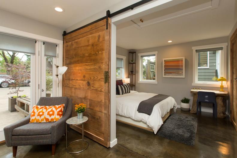 To give a two-car garage new life as a guest house, contractor Kelbe Cronen of Cronen Building Co. took care to incorporate rich, rustic elements in the updated design. “The wood barn door was built using the original ship from the garage and the existing concrete floor was ground down, sanded, and polished,” he says.