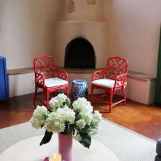Adobe Fireplace and Two Red Chairs