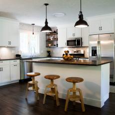 White Open Plan Kitchen With Wood Stools