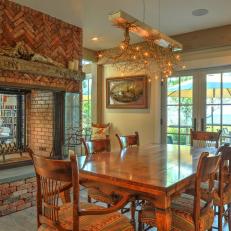Rustic Dining Room With Brick Fireplace