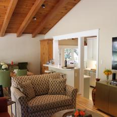 Open Concept Living And Dining Room With Vaulted Ceiling With Exposed Beams And Rafters