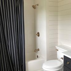 Black and White Pinstripe Shower Curtain Adds Funky Flair to Black and White Guest Bathroom 