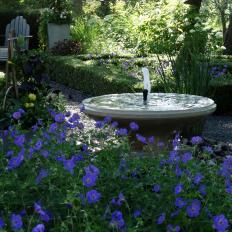 Limestone Fountain and Purple Flowers
