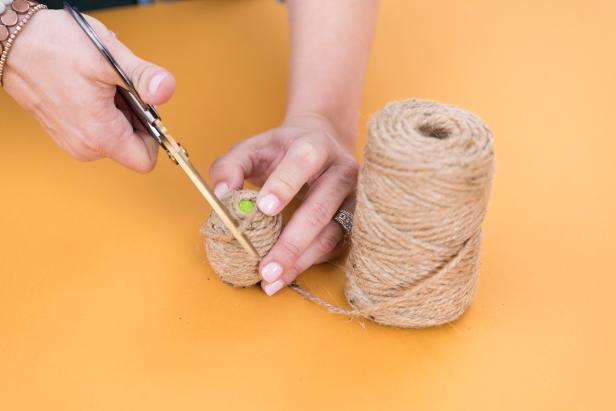 When you get to the other end, cut the twine and add a dab of hot glue. Place the end of the twine on top.