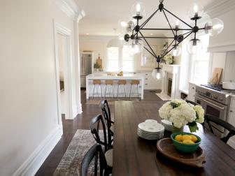 White Kitchen and Dining Room with Wood Brown Floors, Black Chandelier 