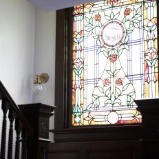 Brown Victorian Stairway with Multicolor Stained Glass Window
