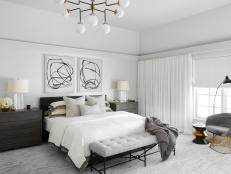 transitional master bedroom with black and white art