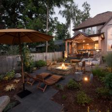 Backyard With Umbrella and Fire Pit