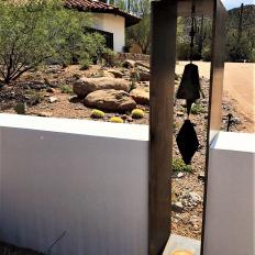 Desert Stone Retaining Wall with Rustic Metal Bell