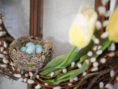 Give your front door a cheery spring makeover with this easy-to-craft wreath that features a DIY bird's nest complete with hand-painted robin's eggs.