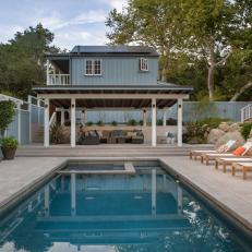 Pool and Patio With Blue Home Exterior
