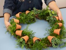 Fill gaps by hot gluing faux moss around the wreath.