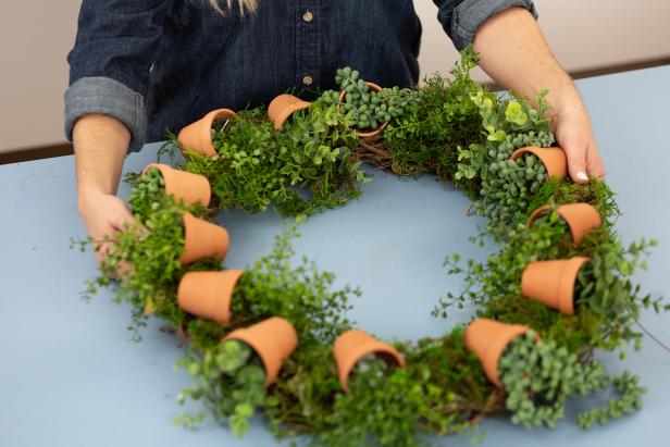 Fill gaps by hot gluing faux moss around the wreath.