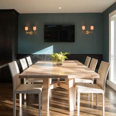 Blue Dining Area With Brass Sconces