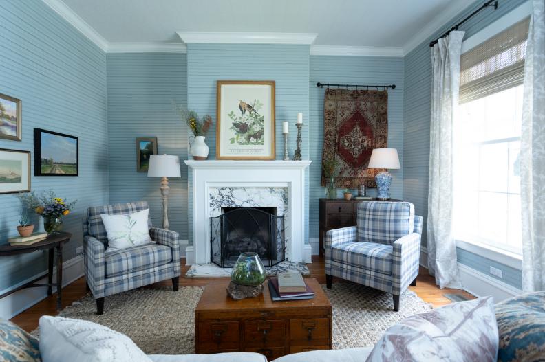 As seen on Home Town, Ben and Erin Napier have completely renovated the Hogue Residence in Laurel, Mississippi.  In the living room, bead board in perfect condition was discoved under the dark green sheetrock walls.  The marble fireplace was left and a new hearth and paint helped to update the space. (after)