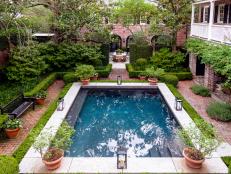 A raised plunge pool offers a respite from the Southern heat and a peaceful focal point in the main courtyard of this  Charleston garden.