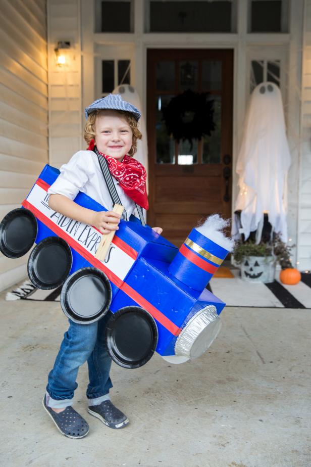 A Boy in a Blue Train Costume Made Out of Cardboard