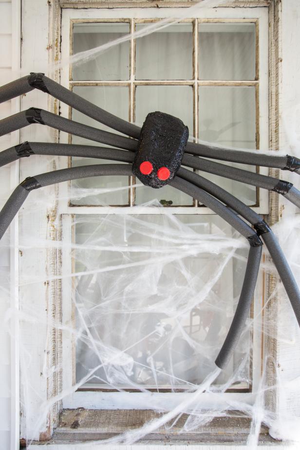 A White Window With a Giant Black Spider Halloween Decoration