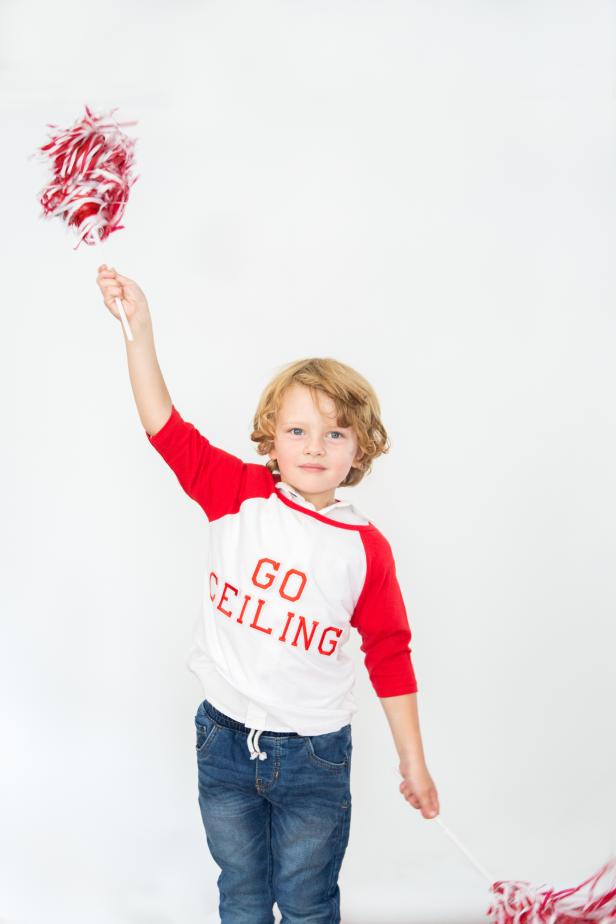 A Boy in a Shirt That Says Go Ceiling With Pompoms