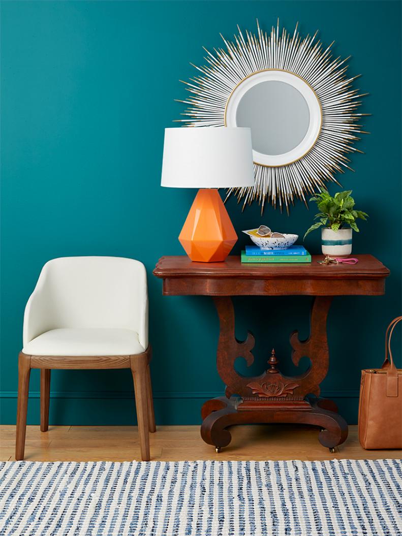 The best way to make an ornate heirloom not stodgy: Bring in finds with modern shapes and textures, like this funky mirror, geo lamp, and mixed-materials chair. Boom! That ancient table is entryway-worthy. 