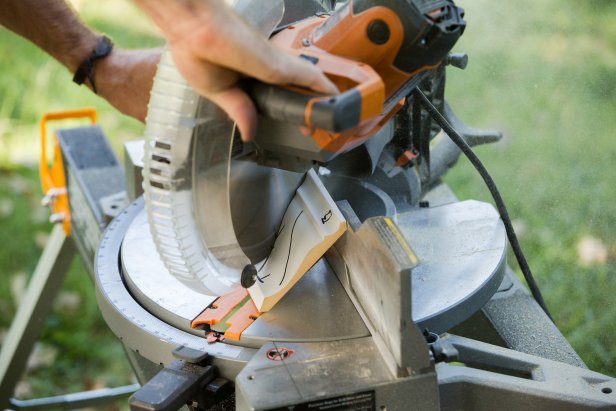 Swivel the saw to a 45-degree angle to match the direction of the molding, set the board against the saw at the mark and make the cut.