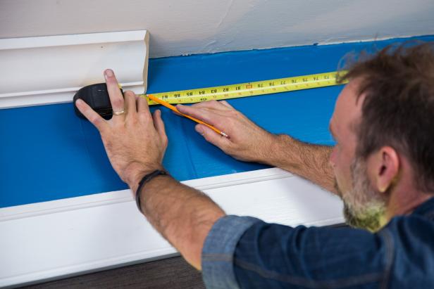 For every cut, measure the wall where the bottom of the crown molding will sit. Measure corner to corner. Mark the wall measurement on the bottom of the crown molding.