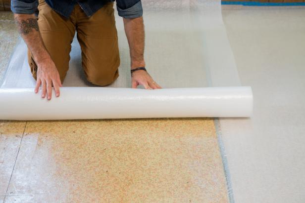 Thoroughly clean the subfloor so that there is no debris on the floor and that it is flat and smooth. Directly onto the subfloor, lay down a layer of plastic sheeting to create a moisture barrier.