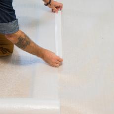 How to Install Laminate Flooring: Overlap Plastic Sheeting