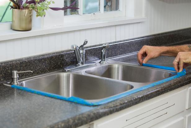 Now that the countertop is prepped for painting, you’ll want to protect everything that’s not going to get primed and painted. Use painter’s tape to protect the sink and walls.