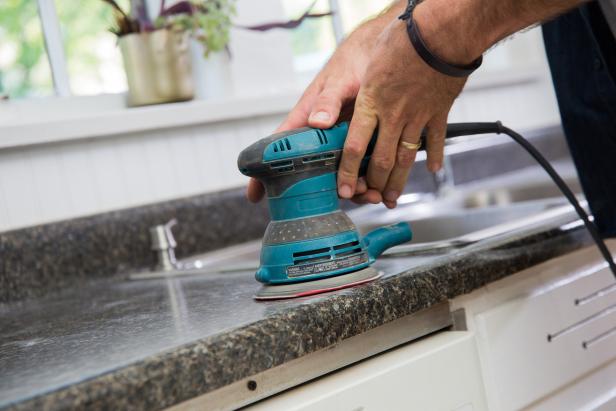 It’s a good idea to sand any surface before you paint. Use a fine-grit (200 to 220) sandpaper to remove any rough spots on your counter and backsplash.